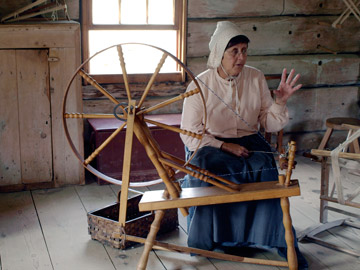 Working at the spinning wheel at Village Historique Acadien